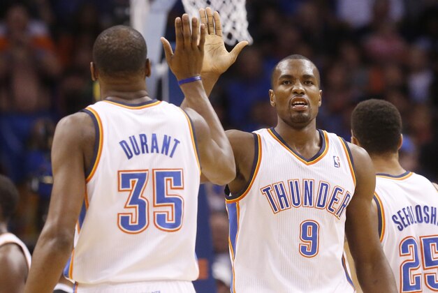 Oklahoma City Thunder forward Serge Ibaka (9) high fives teammate Kevin Durant (35) in the first quarter of an NBA basketball game against the Sacramento Kings in Oklahoma City, Sunday, Jan. 19, 2014. (AP Photo/Sue Ogrocki)