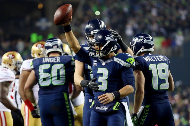 SEATTLE, WA - JANUARY 19:  Quarterback Russell Wilson #3 of the Seattle Seahawks celebrates as the Seahawks defeat the San Francisco 49ers 23-17 during the 2014 NFC Championship at CenturyLink Field on January 19, 2014 in Seattle, Washington.  (Photo by Ronald Martinez/Getty Images)