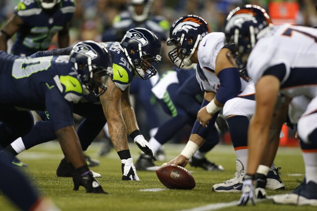 Seattle Seahawks' Jesse Williams (90) lines up with teammates at the line of scrimmage against the Denver Broncos in the second half of a preseason NFL football game, Saturday, Aug. 17, 2013, in Seattle. (AP Photo/John Froschauer)