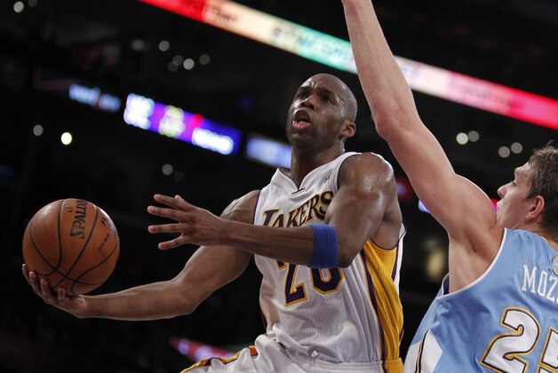 Los Angeles Lakers guard Jodie Meeks, left, lays up a shot against Denver Nuggets center Timofey Mozgov, right, of Russia during the first half of an NBA basketball game, Sunday, Jan. 5, 2014, in Los Angeles. (AP Photo/Alex Gallardo)