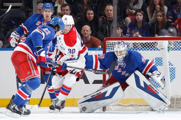 NEW YORK, NY - JANUARY 19:  Henrik Lundqvist #30 of the New York Rangers tracks down the loose puck in front of the net against the Washington Capitals at Madison Square Garden on January 19, 2014 in New York City. (Photo by Scott Levy/NHLI via Getty Images)