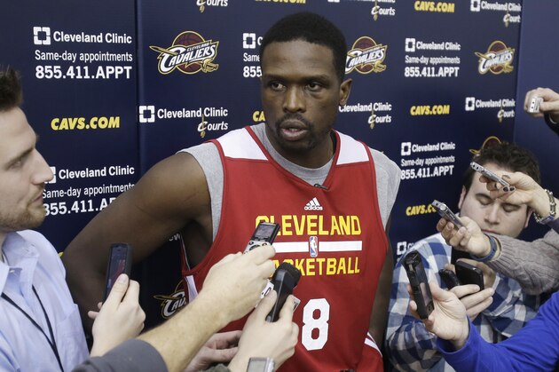New Cleveland Cavaliers forward Luol Deng talks with reporters after his first practice with the NBA team at their practice facility in Independence, Ohio Wednesday, Jan. 8, 2014. The Cavaliers traded Andrew Bynum and future draft choices for the two-time All-Star Tuesday. (AP Photo/Mark Duncan)