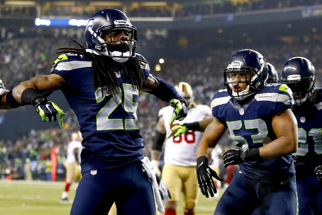 SEATTLE, WA - JANUARY 19:  Cornerback Richard Sherman #25 of the Seattle Seahawks celebrates after he tips the ball leading to an intereption by outside linebacker Malcolm Smith #53 to clinch the victory for the Seahawks against the San Francisco 49ers during the 2014 NFC Championship at CenturyLink Field on January 19, 2014 in Seattle, Washington.  (Photo by Jonathan Ferrey/Getty Images)