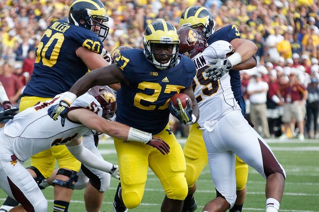 ANN ARBOR, MI - AUGUST 31: Derrick Green #27 of the Michigan Wolverines tries to avoid the tackle of Cody Lopez #51 of the Central Michigan Chippewas at Michigan Stadium on August 31, 2013 in Ann Arbor, Michigan. Michigan won the 59-9. (Photo by Gregory Shamus/Getty Images)