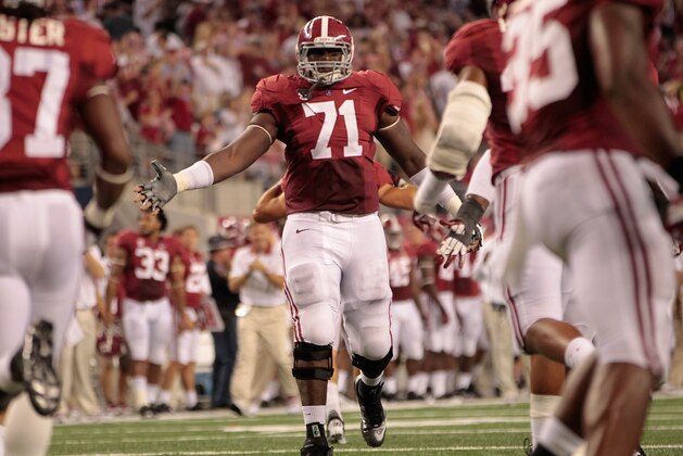 ARLINGTON, TX - SEPTEMBER 01: Cyrus Kouandjio #71 of the University of Alabama reacts after a big stop during the game against the University of Michigan at Cowboys Stadium on September 1, 2012 in Arlington, Texas. Alabama defeated Michigan 41-14.  (Photo by Leon Halip/Getty Images)