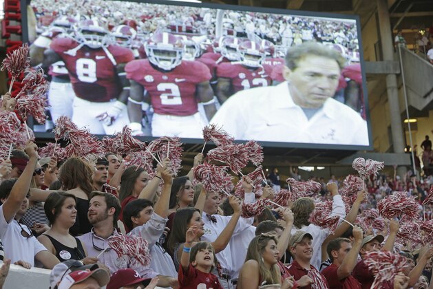 Alabama fans react as the Crimson Tide runs on the field during the first half of an NCAA college football game against Mississippi in Tuscaloosa, Ala., Saturday, Sept. 28, 2013. (AP Photo/Dave Martin)