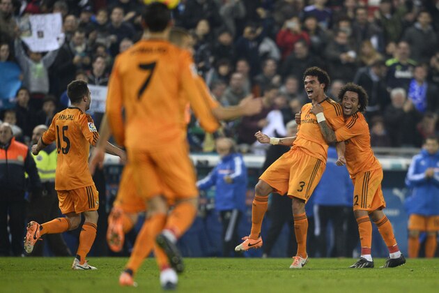 Real Madrid's Pepe, from Portugal, second right, reacts after scoring with his teammate Marcelo, from Brazil, right, against Espanyol during a Spanish La Liga soccer match at Cornella-El Prat stadium in Cornella Llobregat, Spain, Sunday, Jan. 12, 2014. (AP Photo/Manu Fernandez)