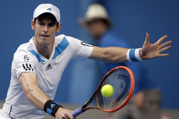 Andy Murray of Britain makes a backhand return to Stephane Robert of France during their fourth round match at the Australian Open tennis championship in Melbourne, Australia, Monday, Jan. 20, 2014.(AP Photo/Rick Rycroft)