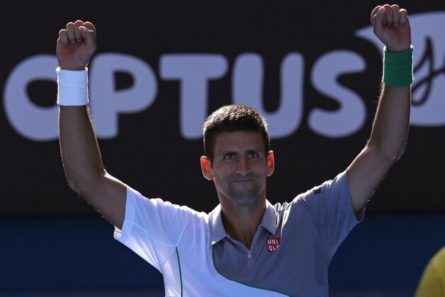 Novak Djokovic of Serbia celebrates his win over Fabio Fognini of Italy during their fourth round match at the Australian Open tennis championship in Melbourne, Australia, Sunday, Jan. 19, 2014.(AP Photo/Eugene Hoshiko)