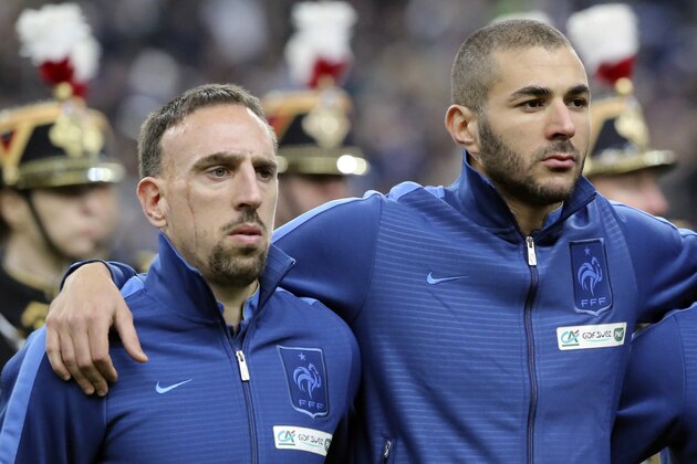 FILE - In this Nov.19, 2013 file photo, From left, Franck Ribery, left, and Karim Benzema pay attention to the French national anthem during a World Cup qualifying playoff second-leg soccer match France against Ukraine at Stade de France stadium in Saint Denis, outside Paris.  A trial involving Bayern Munich winger Franck Ribery and Real Madrid forward Karim Benzema is back on track Monday Jan.20, 2014, with the two facing up to three years in prison on charges of soliciting an underage prostitute. (AP Photo/Michel Euler, File)
