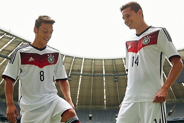 MUNICH, GERMANY - SEPTEMBER 02:  Mesut Oezil (l) and Julian Draxler presenting the new German National Team Kit during a training session at Allianz Arena on September 2, 2013 in Munich, Germany.  (Photo by Pool/Getty Images)