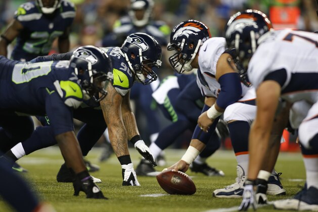 Seattle Seahawks' Jesse Williams (90) lines up with teammates at the line of scrimmage against the Denver Broncos in the second half of a preseason NFL football game, Saturday, Aug. 17, 2013, in Seattle. (AP Photo/John Froschauer)