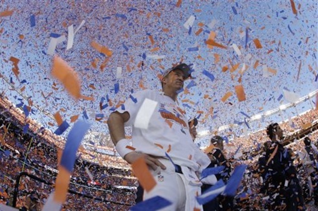 Denver Broncos quarterback Peyton Manning is engulfed in confetti during the trophy ceremony after the AFC Championship NFL playoff football game in Denver, Sunday, Jan. 19, 2014. The Broncos defeated the Patriots 26-16 to advance to the Super Bowl. (AP Photo/Charlie Riedel)