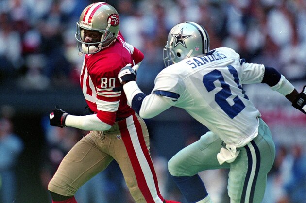 12 Nov 1995: Jerry Rice #80 of the San Francisco 49ers runs with the ball as Deion Sanders #21 of the Dallas Cowboys runs after him during the game at the Texas Stadium in Irving, Texas. The 49ers defeated the Cowboys 38-20.