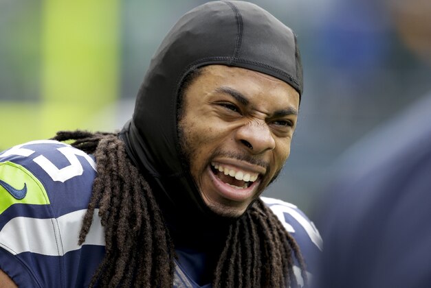 Seattle Seahawks cornerback Richard Sherman smiles before an NFC divisional playoff NFL football game against the New Orleans Saints in Seattle, Saturday, Jan. 11, 2014. (AP Photo/Elaine Thompson)