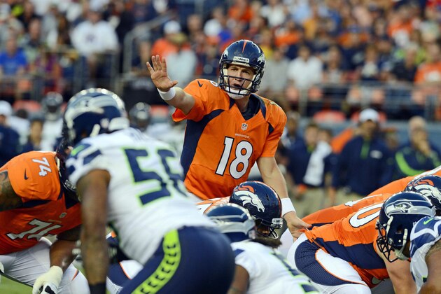 August 18 2012; Denver, CO, USA; Denver Broncos quarterback Peyton Manning (18) in the second quarter of a preseason game against the Seattle Seahawks at Sports Authority Field. Mandatory Credit: Ron Chenoy-USA TODAY Sports