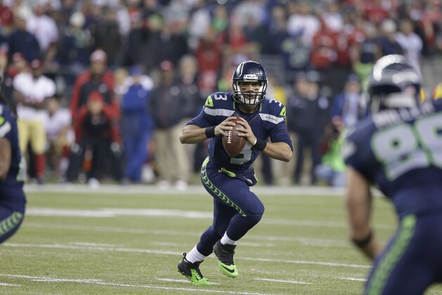 Seattle Seahawks' Russell Wilson (3) works against the San Francisco 49ers during the second half of the NFL football NFC Championship game Sunday, Jan. 19, 2014, in Seattle. (AP Photo/Elaine Thompson)