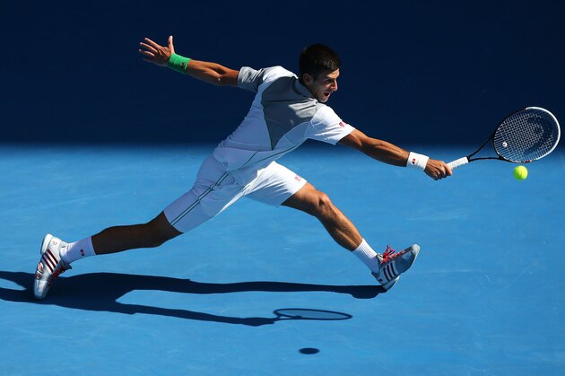 MELBOURNE, AUSTRALIA - JANUARY 19:  Novak Djokovic of Serbia plays a backhand in his fourth round match against Fabio Fognini of Italy during day seven of the 2014 Australian Open at Melbourne Park on January 19, 2014 in Melbourne, Australia.  (Photo by Chris Hyde/Getty Images)