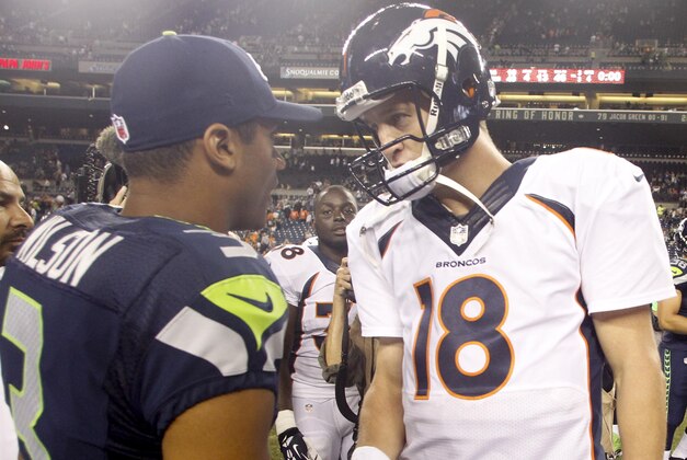 Aug 17, 2013; Seattle, WA, USA; Seattle Seahawks quarterback Russell Wilson (3) and Denver Broncos quarterback Peyton Manning (18) speak following a 40-10 preseason victory by the Seahawks at CenturyLink Field. Mandatory Credit: Joe Nicholson-USA TODAY Sports