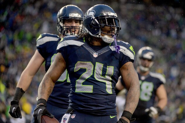 SEATTLE, WA - JANUARY 11:  Running back Marshawn Lynch #24 of the Seattle Seahawks celebrates after he scores a 31-yard touchdown run against the New Orleans Saints in the fourth quarter during the NFC Divisional Playoff Game at CenturyLink Field on January 11, 2014 in Seattle, Washington.  (Photo by Harry How/Getty Images)