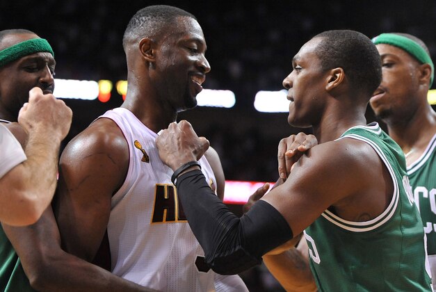 Oct 30, 2012; Miami, FL, USA; Boston Celtics point guard Rajon Rondo (right) gestures at Miami Heat shooting guard Dwyane Wade (3) during the second half at American Airlines Arena. The Heat won 120-107. Mandatory Credit: Steve Mitchell-USA TODAY Sports