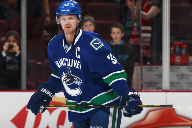 VANCOUVER, BC - JANUARY 7:  Henrik Sedin #33 of the Vancouver Canucks skates up ice during their NHL game against the Pittsburgh Penguins at Rogers Arena January 7, 2014 in Vancouver, British Columbia, Canada. Pittsburgh won 5-4 in a shootout. (Photo by Jeff Vinnick/NHLI via Getty Images)