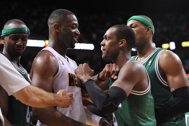 Oct 30, 2012; Miami, FL, USA; Boston Celtics point guard Rajon Rondo (second from right) gestures at Miami Heat shooting guard Dwyane Wade (second from left) during the second half at American Airlines Arena. The Heat won 120-107. Mandatory Credit: Steve Mitchell-USA TODAY Sports