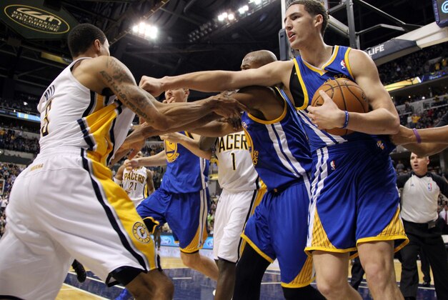 Feb 26 2013; Indianapolis, IN, USA; Indiana Pacers guard George Hill (3) gets punched by Golden State Warriors guard Klay Thompson (11) as a fight breaks out during the game at Bankers Life Fieldhouse. Mandatory Credit: Brian Spurlock-USA TODAY Sports