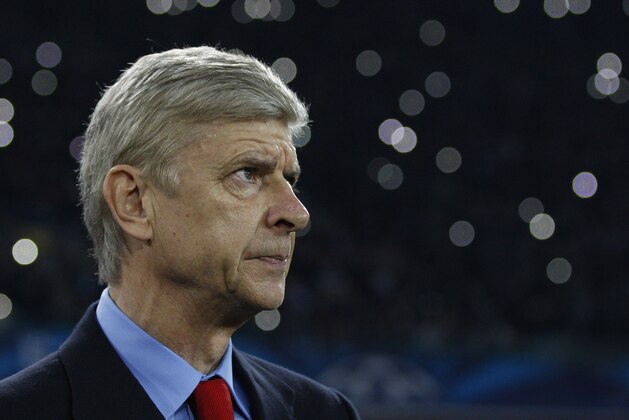 Arsenal's manager Arsene Wenger waits for the start of a Champions League, group F soccer match between Arsenal and Napoli, at the Naples San Paolo stadium, Italy, Wednesday, Dec. 11, 2013. (AP Photo/Andrew Medichini)