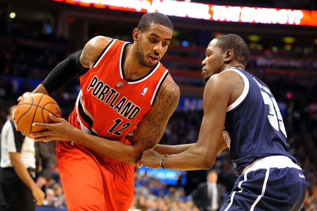 Dec 31, 2013; Oklahoma City, OK, USA; Portland Trail Blazers power forward LaMarcus Aldridge (12) handles the ball while guarded by Oklahoma City Thunder small forward Kevin Durant (35) during the second quarter at Chesapeake Energy Arena. Mandatory Credit: Mark D. Smith-USA TODAY Sports