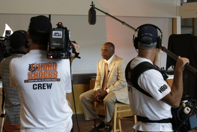 An HBO Hard Knocks television crew films Cincinnati Bengals head coach Marvin Lewis being interviewed at the NFL football team's annual media luncheon, Tuesday, July 23, 2013, in Cincinnati. The Bengals open training camp Thursday. (AP Photo/Al Behrman)