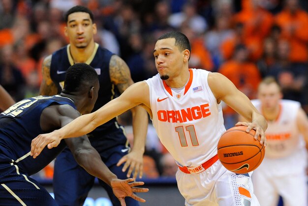 Jan 18, 2014; Syracuse, NY, USA; Syracuse Orange guard Tyler Ennis (11) drives to the basket around Pittsburgh Panthers forward Talib Zanna (left) during the second half at the Carrier Dome.  Syracuse defeated Pittsburgh 59-54.  Mandatory Credit: Rich Barnes-USA TODAY Sports