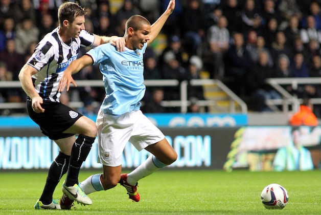 NEWCASTLE, UNITED KINGDOM - OCTOBER 30:  Jack Rodwell (R) of Manchester City goes down under a challenge from Mike Williamson of Newcastle United during the Capital One Cup Fourth Round match between Newcastle United and Manchester City at St James' Park on October 30, 2013 in Newcastle upon Tyne, England (Photo by Ian Horrocks/Getty Images)