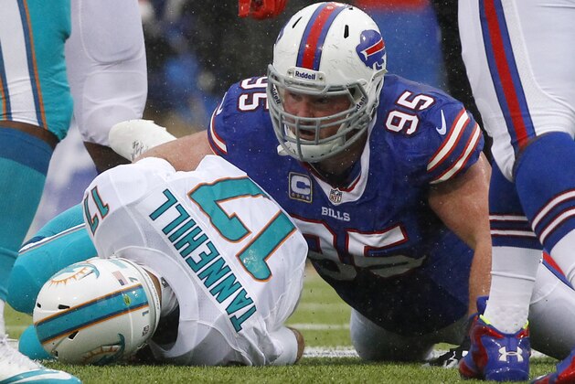 Buffalo Bills defensive tackle Kyle Williams (95) sacks Miami Dolphins quarterback Ryan Tannehill (17) during the first half of an NFL football game on Sunday, Dec. 22, 2013, in Orchard Park, N.Y. (AP Photo/Bill Wippert)