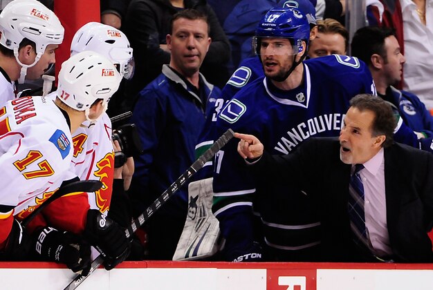 Jan 18, 2014; Vancouver, British Columbia, CAN; Vancouver Canucks head coach John Tortorella and forward Ryan Kesler (17) talk to the Calgary Flames defenseman Shane O'Brien (55) and forward Lance Bouma (17) and Calgary Flames forward Jiri Hudler (24) during the first period at Rogers Arena. Mandatory Credit: Anne-Marie Sorvin-USA TODAY Sports
