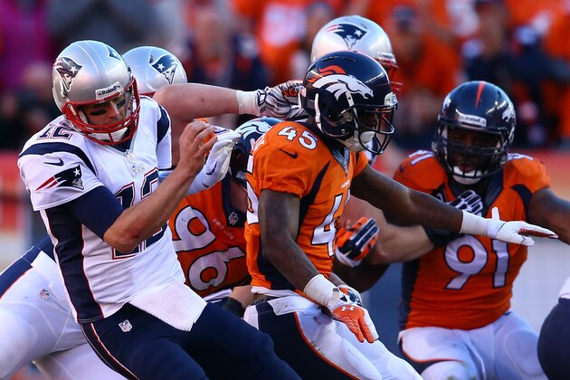 DENVER, CO - JANUARY 19:  Tom Brady #12 of the New England Patriots in action against the Denver Broncos during the AFC Championship game at Sports Authority Field at Mile High on January 19, 2014 in Denver, Colorado.  (Photo by Doug Pensinger/Getty Images)