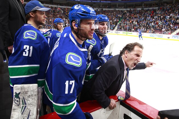 VANCOUVER, BC - JANUARY 18:  Ryan Kesler #17 and Eddie Lack #31 stand beside head coach John Tortorella of the Vancouver Canucks as he exchanges words with players and coaches of the Calgary Flames during their NHL game at Rogers Arena January 18, 2014 in Vancouver, British Columbia, Canada.  (Photo by Jeff Vinnick/NHLI via Getty Images)