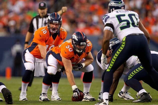 DENVER, CO - AUGUST 18:  Quarterback Peyton Manning #18 of the Denver Broncos signals against the Seattle Seahawks at Sports Authority Field Field at Mile High on August 18, 2012 in Denver, Colorado. (Photo by Justin Edmonds/Getty Images)