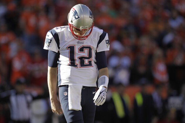 New England Patriots quarterback Tom Brady  walks off the field after the first half of the AFC Championship NFL playoff football game against the Denver Broncos in Denver, Sunday, Jan. 19, 2014. (AP Photo/Joe Mahoney)
