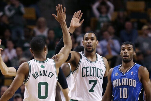 Boston Celtics forward Jared Sullinger (7) and guard Avery Bradley celebrate a point against the Orlando Magic during the second half of an NBA basketball game, in Boston, Monday, Nov. 11, 2013. The Celtics defeated the Magic 120-105. At right is Orlando Magic point guard Ronnie Price (10). (AP Photo/Charles Krupa)