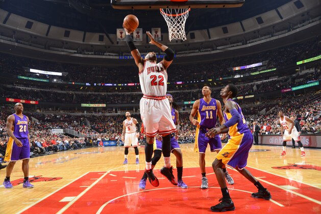 CHICAGO, IL - JANUARY 20: Taj Gibson #22 of the Chicago Bulls goes to the basket over Manny Harris #3 and Wesley Johnson #11 of the Los Angeles Lakers on January 20, 2014 at the United Center in Chicago, Illinois. NOTE TO USER: User expressly acknowledges and agrees that, by downloading and/or using this photograph, user is consenting to the terms and conditions of the Getty Images License Agreement.  Mandatory Copyright Notice: Copyright 2014 NBAE (Photo by Jesse D. Garrabrant/NBAE via Getty Images)