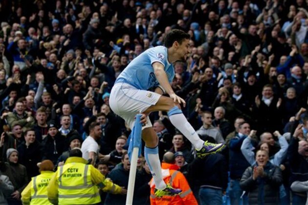 Manchester City's Jesus Navas celebrates after scoring against Cardiff City during their English Premier League soccer match at the Etihad Stadium, Manchester, England, Saturday Jan 18, 2014. (AP Photo/Jon Super)
