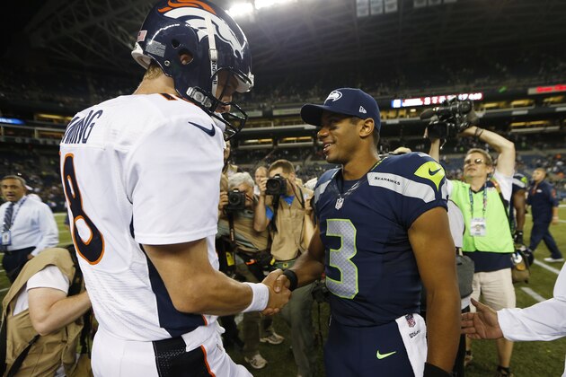 Seattle Seahawks quarterback Russell Wilson (3) shakes hands with Denver Broncos quarterback Peyton Manning, left, after the Seahawks beat the Broncos 40-10, in preseason NFL football game, Saturday, Aug. 17, 2013, in Seattle. (AP Photo/John Froschauer)