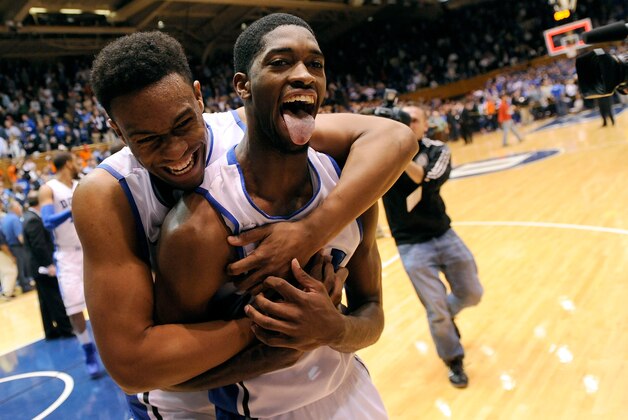 DURHAM, NC - JANUARY 13:  Jabari Parker #1 and Amile Jefferson #21 of the Duke Blue Devils celebrate as they leave the floor following a last-second win over the Virginia Cavaliers at Cameron Indoor Stadium on January 13, 2014 in Durham, North Carolina. Duke won 69-65.  (Photo by Grant Halverson/Getty Images)