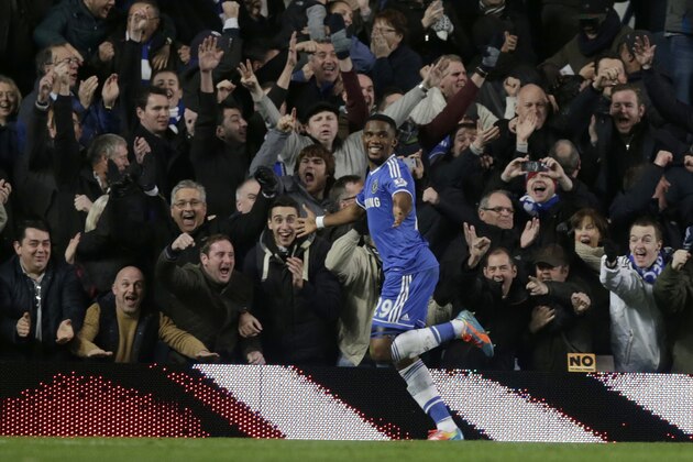 Chelsea's Samuel Eto'o, left, celebrates after his hat-trick against Manchester United during the English Premier League soccer match between Chelsea and Manchester United at Stamford Bridge stadium in London, Sunday, Jan. 19, 2014. (AP Photo/Matt Dunham)