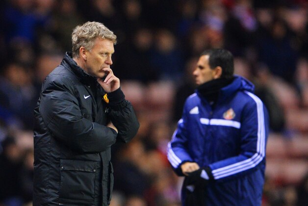 SUNDERLAND, ENGLAND - JANUARY 07:  David Moyes manager of Manchester United and Sunderland manager Gustavo Poyet look on during the Capital One Cup Semi-Final, first leg match between Sunderland and Manchester United at Stadium of Light on January 7, 2014 in Sunderland, England.  (Photo by Michael Regan/Getty Images)