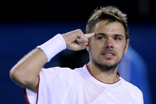 Stanislas Wawrinka of Switzerland celebrates after defeating Novak Djokovic of Serbia in their quarterfinal at the Australian Open tennis championship in Melbourne, Australia, Tuesday, Jan. 21, 2014.(AP Photo/Rick Rycroft)
