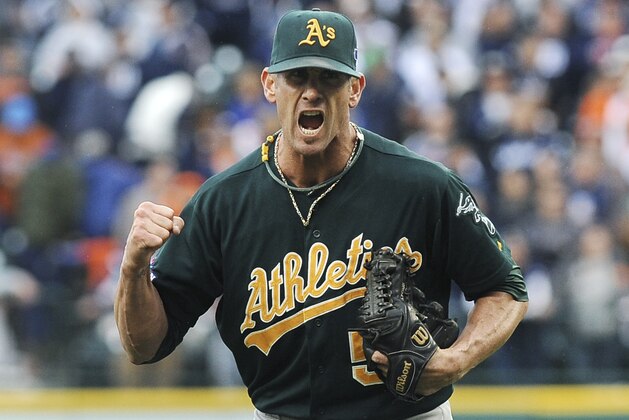 Oakland Athletics relief pitcher Grant Balfour clenches his fist after the final out Game 3 of an American League baseball division series against the Detroit Tigers in Detroit, Monday, Oct. 7, 2013. Oakland won 6-3. (AP Photo/Lon Horwedel)