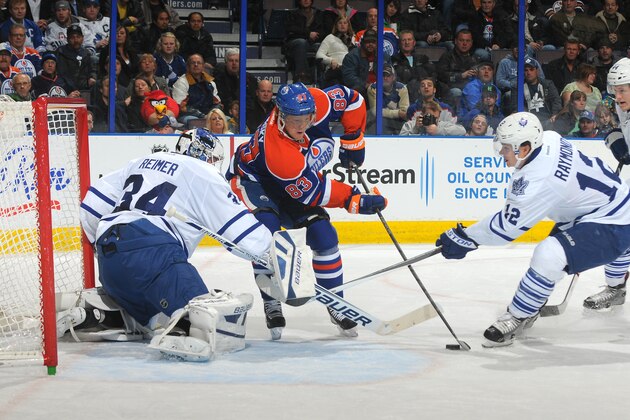 EDMONTON, AB - OCTOBER 29: Ales Hemsky #83 of the Edmonton Oilers takes the puck hard to the net while being chased by Mason Raymond #12 of  the Toronto Maple Leafs on October 29, 2013 at Rexall Place in Edmonton, Alberta, Canada. (Photo by Andy Devlin/NHLI via Getty Images)