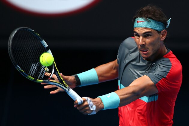 MELBOURNE, AUSTRALIA - JANUARY 20:  Rafael Nadal of Spain plays a backhand in his fourth round match against Kei Nishikori of Japan during day eight of the 2014 Australian Open at Melbourne Park on January 20, 2014 in Melbourne, Australia.  (Photo by Ryan Pierse/Getty Images)